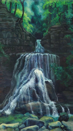 A waterfall descends over layers of dark stone beneath a green forest canopy.