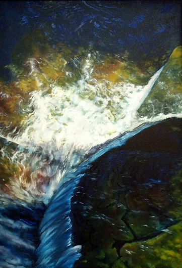 White water spills over a dark rock ledge into blue shadow.