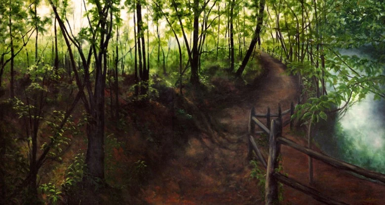 A narrow woodland path follows a wooden fence above a shaded gorge.